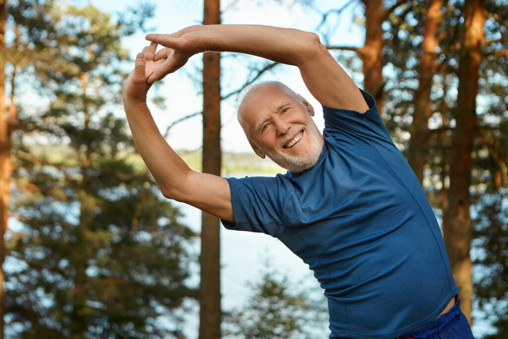 older man, stretching outside