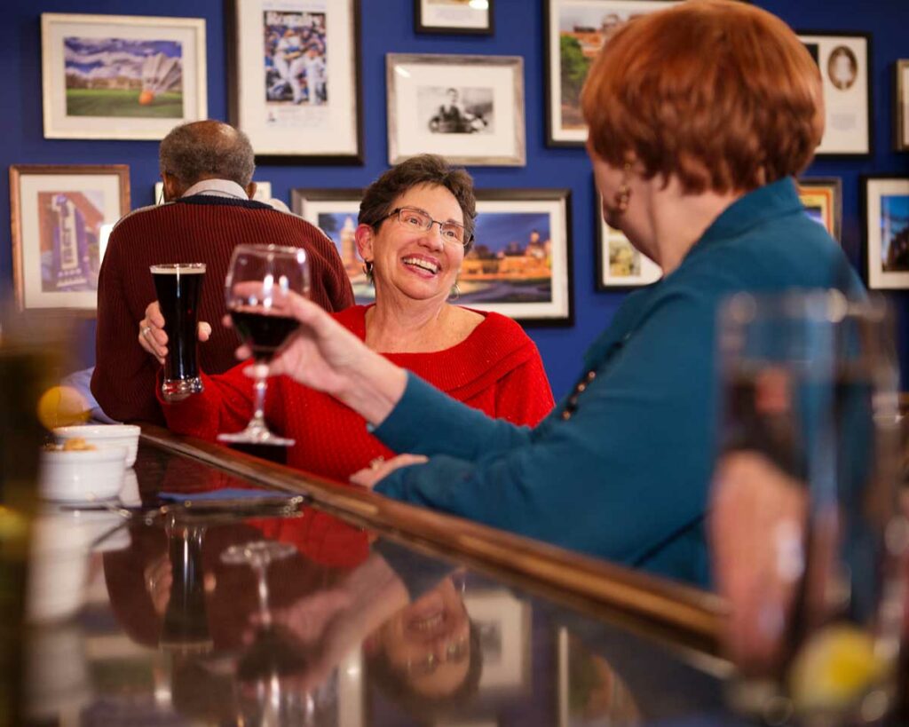 Seniors drink wine and beer at the bar