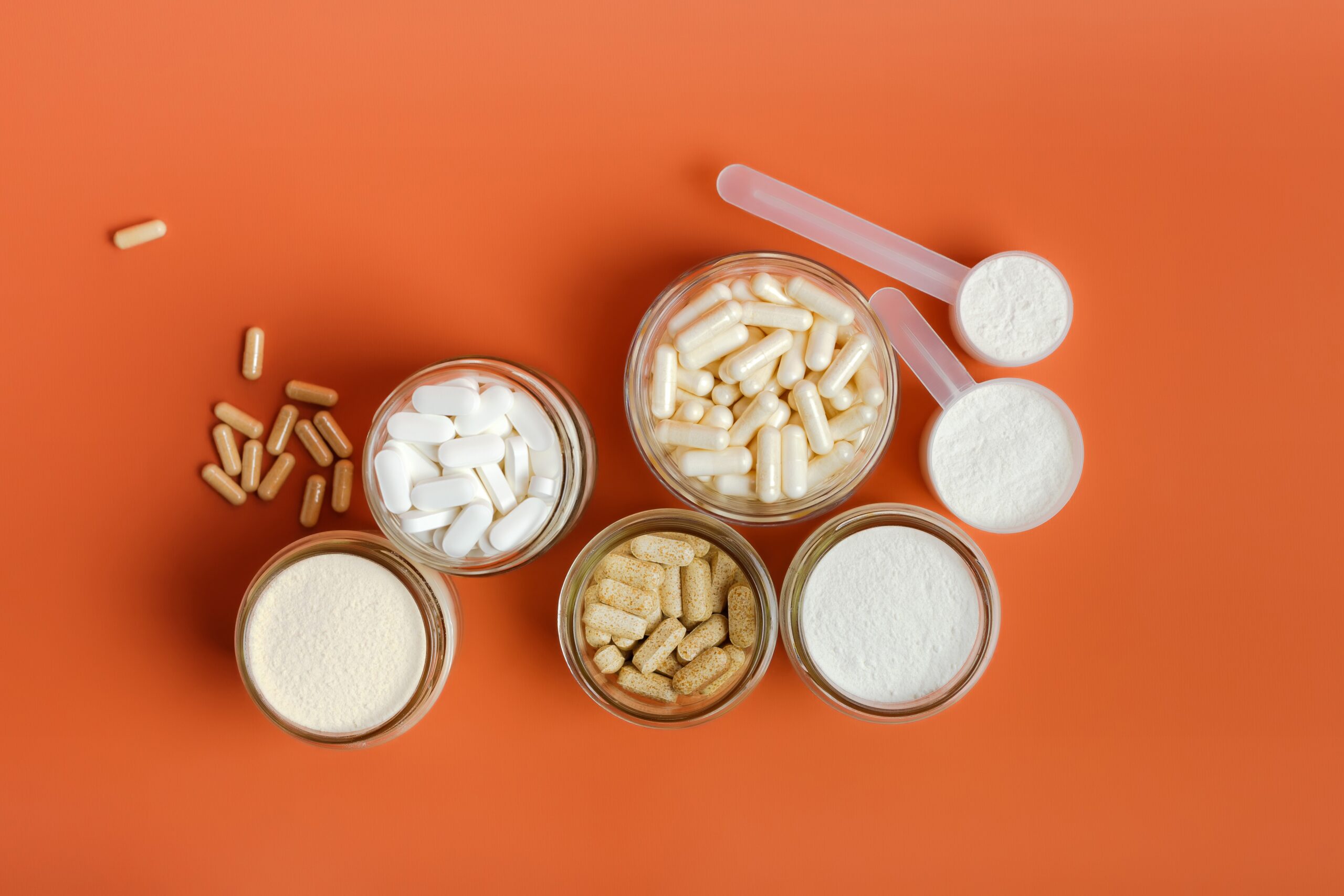 nutrition supplements in cups, including pills and powder