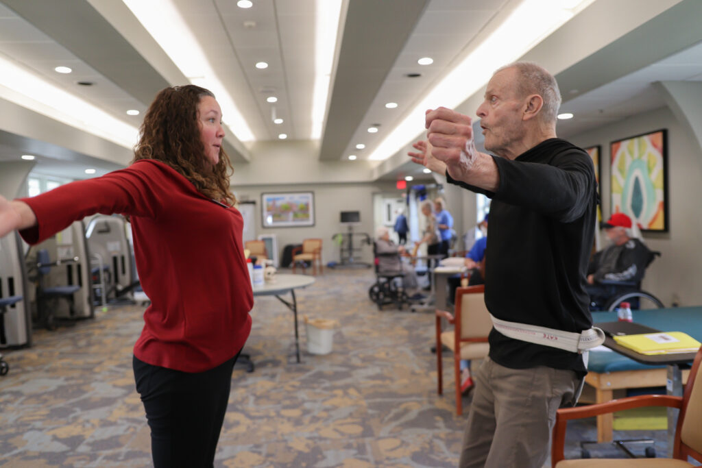 senior working with professional in outpatient therapy