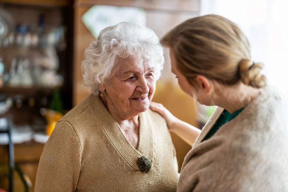 Health visitor talking to a senior woman Health visitor talking to a senior woman during home visit