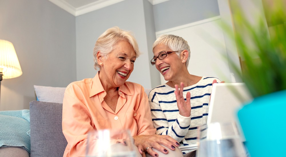 two happy female friends having a conversation