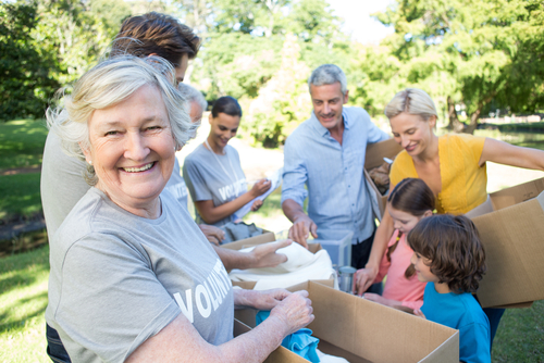 Happy,Volunteer,Family,Separating,Donations,Stuffs,On,A,Sunny,Day Group of people volunteering together